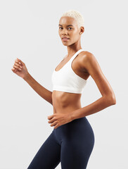 Healthy young female athlete doing fitness workout, Latin American woman engaged in physical activity to support or improve health and fitness. Sportswoman do functional training, wearing sport outfit