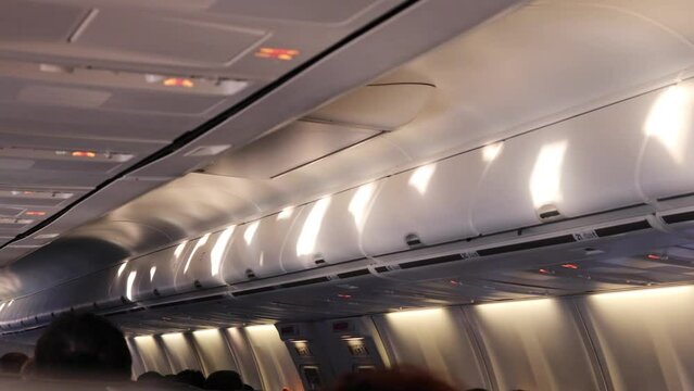 spots of light from illuminator on ceiling and turning off light inside airplane