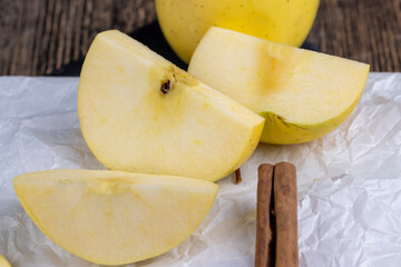 yellow ripe apple with cinnamon on the table
