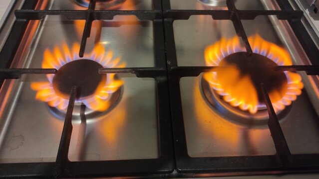 Natural gas burns orange yellow when there is a lack of oxygen. Danger of carbon monoxide poisoning in the kitchen gas stove