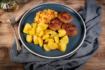 Meatballs  served with fired potatoes.