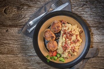 Mince chops served with boiled sauerkraut sprinkled with greaves.