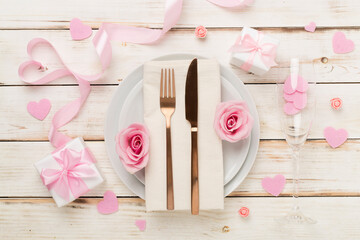 Festive table setting for Valentine's Day on wooden background, top view