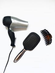 hair dryer, comb and hair clip on white background, hair care