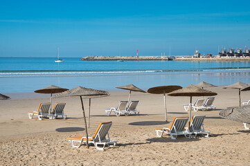 Empty umbrellas and sun loungers on the beach of Essaouira, Morocco