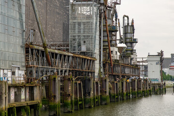 Rotterdam, The Netherlands; Side view of dilapidated equipment and silos of former grain elevator on waterfront now Maassilo event location at Maashaven near the Maas River 