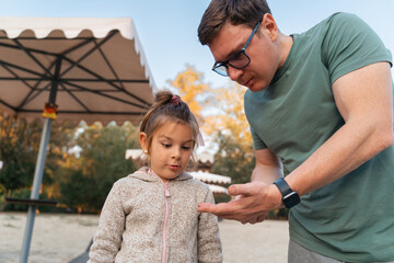Fototapeta premium Father with child girl playing on the riverside, happy modern involved fatherhood. 