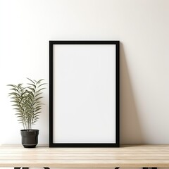 blank black poster frame on light wooden floor, empty picture frame mockup, blank vertical frame