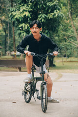 Handsome happy young man with bicycle on a city street, Active lifestyle, people concept