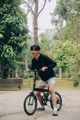 Handsome happy young man with bicycle on a city street, Active lifestyle, people concept