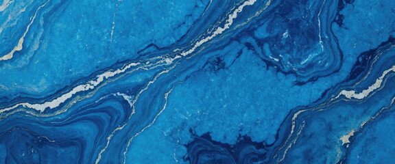 A high-resolution image capturing the detailed pattern of white veins running through the elegant surface of blue marble