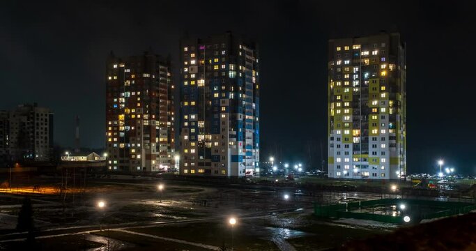 night time lapse with light in windows of multistory buildings. life in a big city. Serenade of light