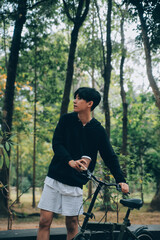 Obraz premium Handsome happy young man with bicycle on a city street, Active lifestyle, people concept