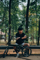 Obraz premium Handsome happy young man with bicycle on a city street, Active lifestyle, people concept