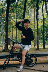 Handsome happy young man with bicycle on a city street, Active lifestyle, people concept