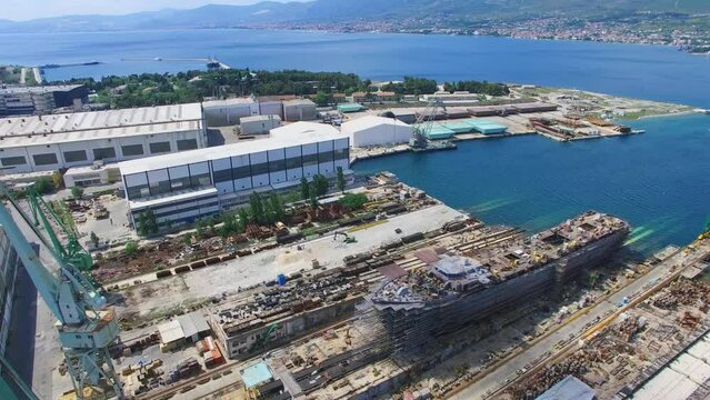 Vessel under construction in Brodosplit shipyard at sunny day. Aerial view