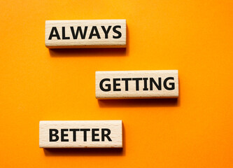 Always getting better symbol. Wooden blocks with words Always getting better. Beautiful orange background. Business and Always getting better concept. Copy space.