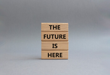 The future is here symbol. Concept words The future is here on wooden blocks. Beautiful grey background. Business and The future is here concept. Copy space.