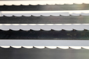 Band-saw blades for wood sawing closeup. Woodworking machine equipment
