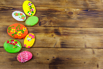 Egg shaped easter gingerbread cookies on wooden table. Top view, copy space. Sweets for celebrate Easter