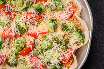 Delicious quiche with tomato, cheese, chicken, spices and herbs