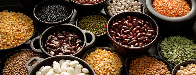 Legumes, a set consisting of different types of beans, lentils and peas on a black background, ...