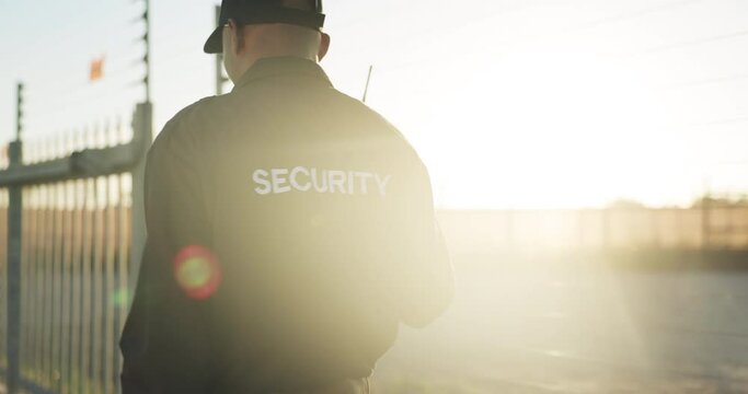 Security guard, radio and back of man on patrol outdoor for inspection, investigation and search. Surveillance, law and person with walkie talkie for safety, communication and protection service