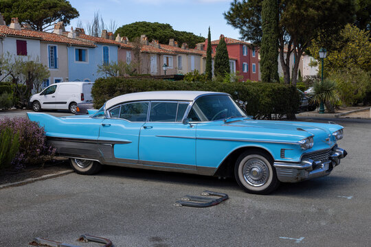 Port Grimaud, France April 14, 2023: Fleetwood light blue sports car with white roof, from America, old, historic with partially rusted chrome bumper