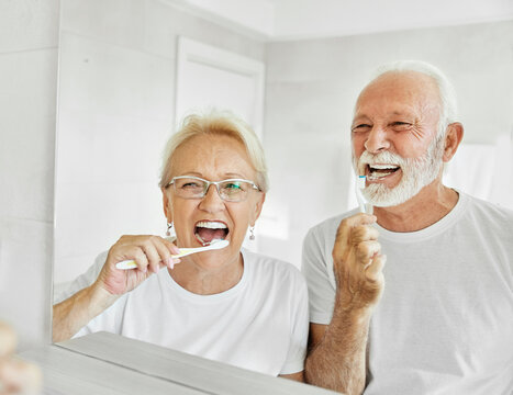 woman tooth bathroom toothbrush hygiene senior morning routine brushing toothpaste care dental elderly home retirement mouth mirror health cleaning man couple