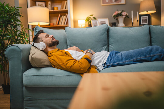 man with headphones practice guided meditation yoga self care at home