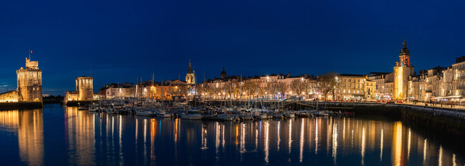 beautiful illuminated cityscape of the old harbor of La Rochelle at night © mathilde