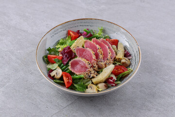 salad with carpaccio, artichoke and asparagus on a stone background, studio food photography 4