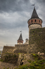 Old Kamianets-Podilskyi Castle under the cloudy sky. Part of the powerful bastions of the castle....