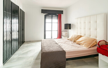 a simple guest bedroom with original wooden wardrobes in mediterranean apartment 