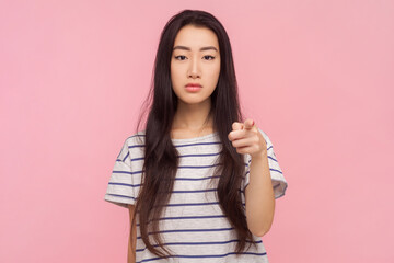 Portrait of bossy strict woman with long brunette hair pointing at camera choosing you displeased...