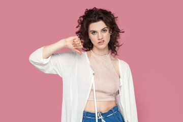 Portrait of sad disappointed woman with curly hair wearing casual style outfit standing showing...
