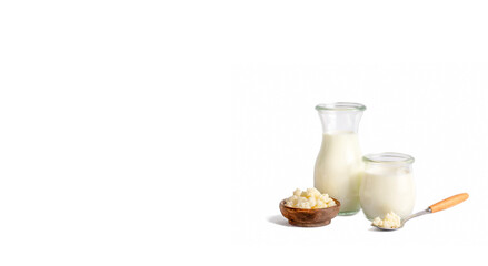 Kefir fermented milk drink with kefir grains. Homemade kefir stands in a glass, next to kefir grains and milk