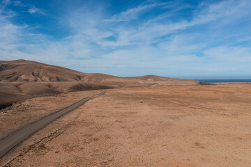 Fototapeta na wymiar aerial view of desert road on fuerteventura