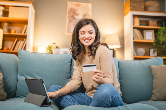 woman use credit car shopping online payment or reservation at home