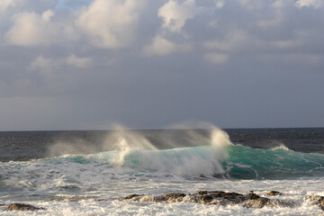 Waves rolling in over volcanic rock in Puert de las Nieves, Gran Canaria, Spain