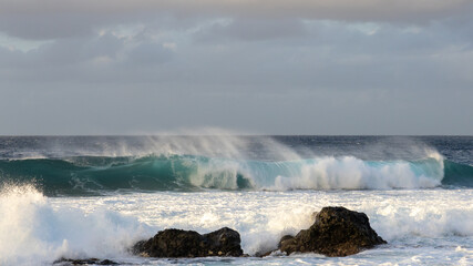 Waves rolling in over volcanic rock in Puert de las Nieves, Gran Canaria, Spain