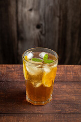 Glass of iced tea with lemon and mint.
