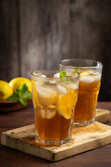 Glass of iced tea with lemon and mint.
