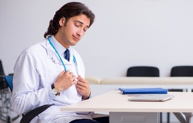 Young doctor being tired after night shift