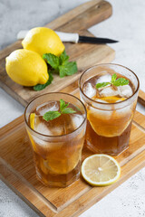 Glass of iced tea with lemon and mint.