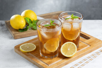 Glass of iced tea with lemon and mint.