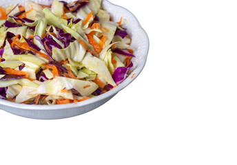 Fresh vegetables salad with purple cabbage, white cabbage, lettuce, carrot on white plate