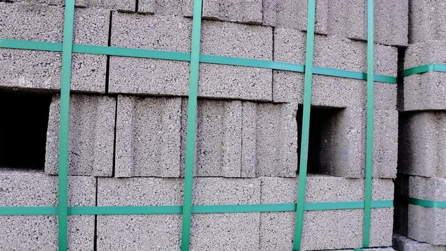 Close-up of blocks at construction site, pumice stone blocks stacked on cubic pallets. Detailed view of blocks, showing texture and arrangement. Construction site focus on blocks