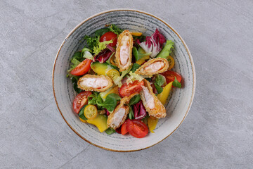 bowl with shrimp in batter, avocado and kumquat on a stone background, studio food photography 1