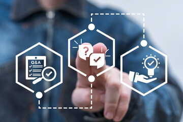 Man using virtual touch screen presses icon of questions and answers: speech balloons with question mark and check mark. Questions and Answers ( Q and A ) Business Web Technology concept.